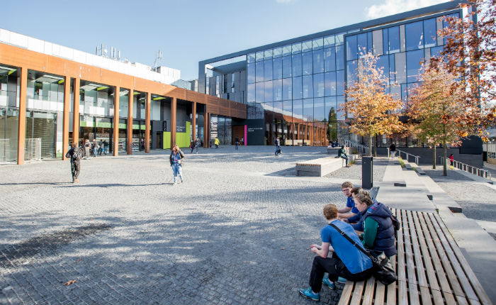 Students sitting outside the John Henry Brookes Building