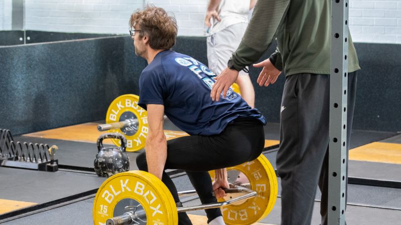 Student lifting weights