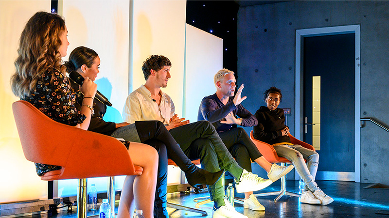 A group of four sat on a stage