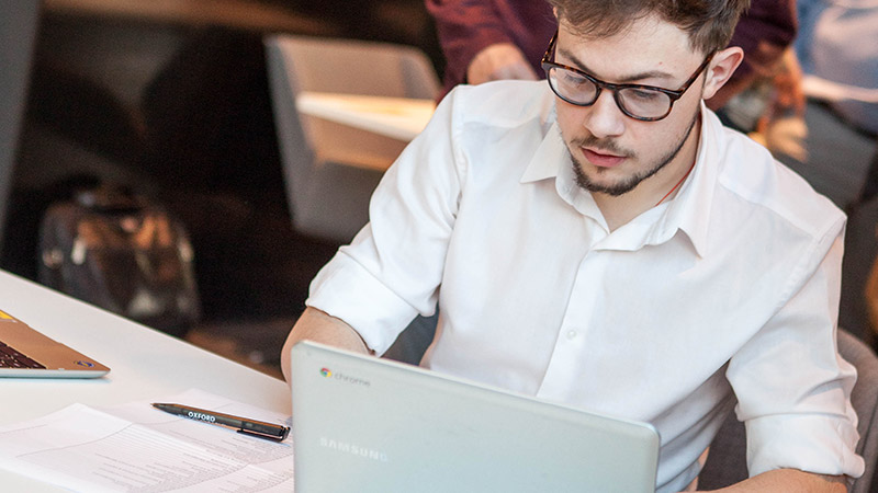 Student researching on a laptop