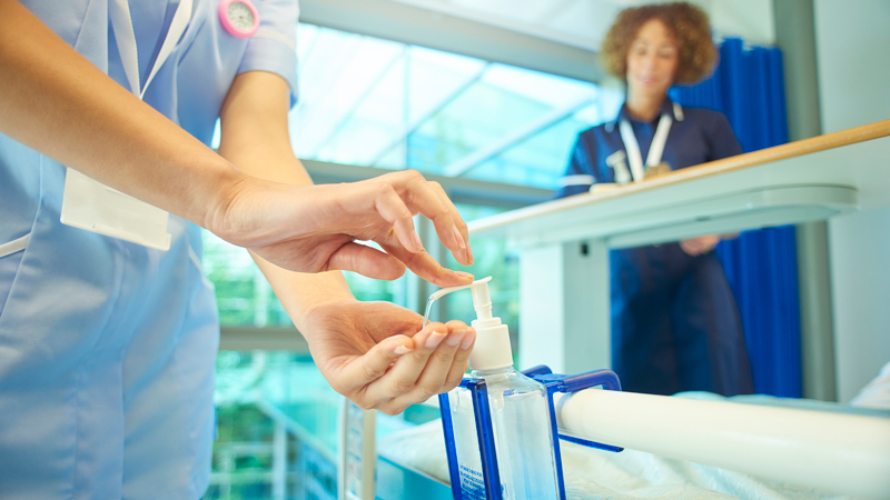 person using hand sanitiser