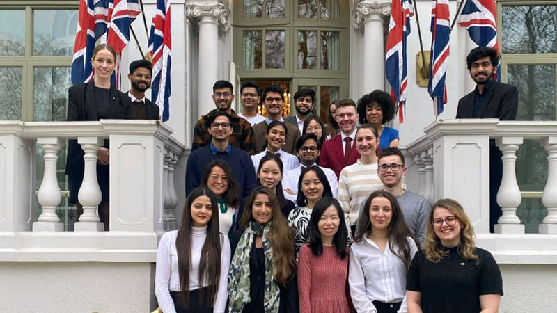 Bacchus Society members standing on steps