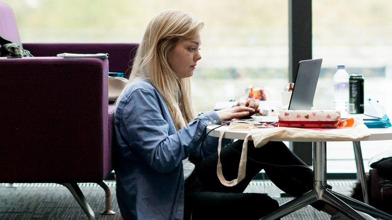 Student typing on a laptop