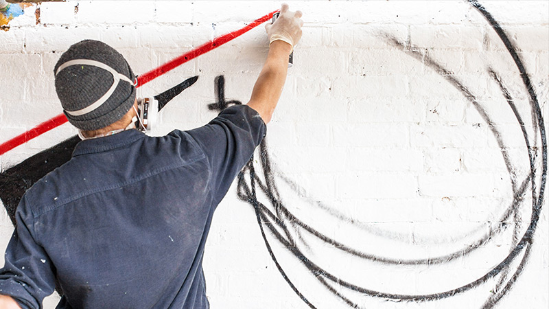 Man spray painting graffiti
