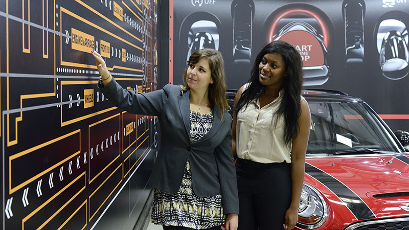 Two girls in car factory