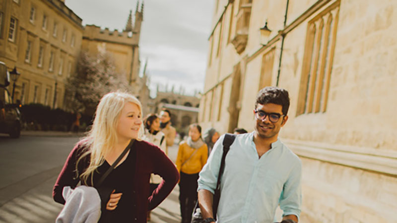 Male and female walking down Oxford street