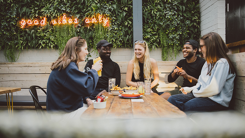 Group of students eating at restaurant