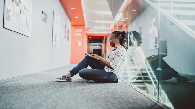 Student typing on a laptop