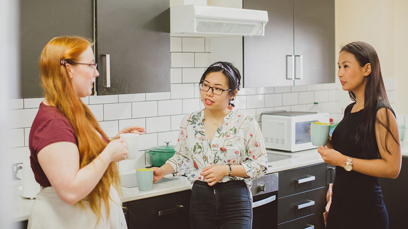 Three students in their accommodation kitchen