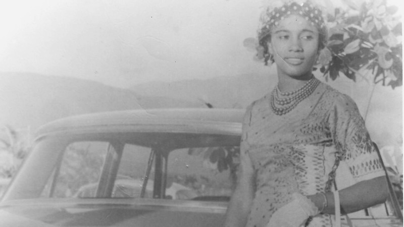Woman standing next to car 