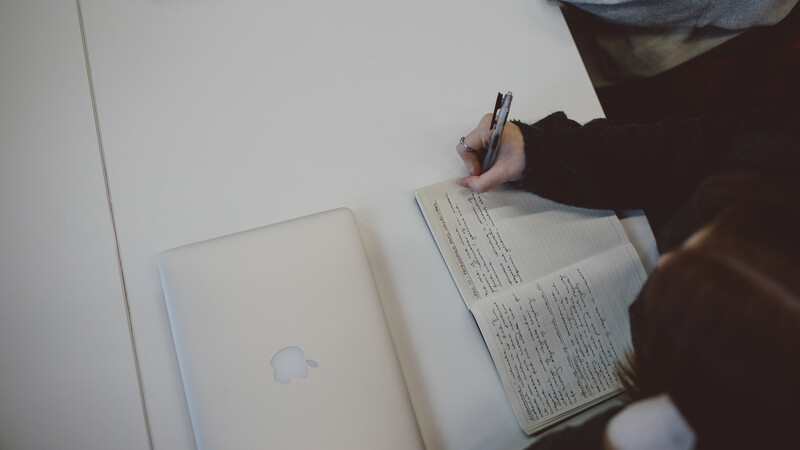 A stock image from the university of a person writing