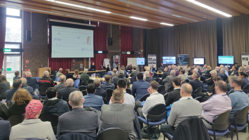 Attendees pictured watching a presentation at the event