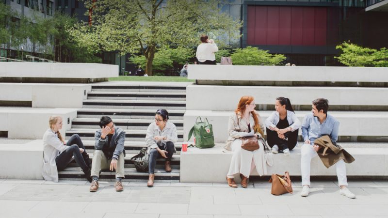 Students sitting outside in the main quad at Oxford Brookes University