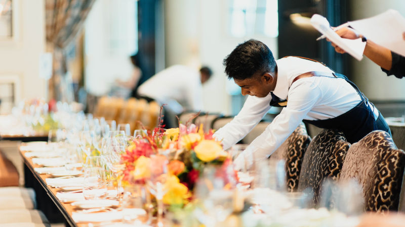 A person placing something on a table