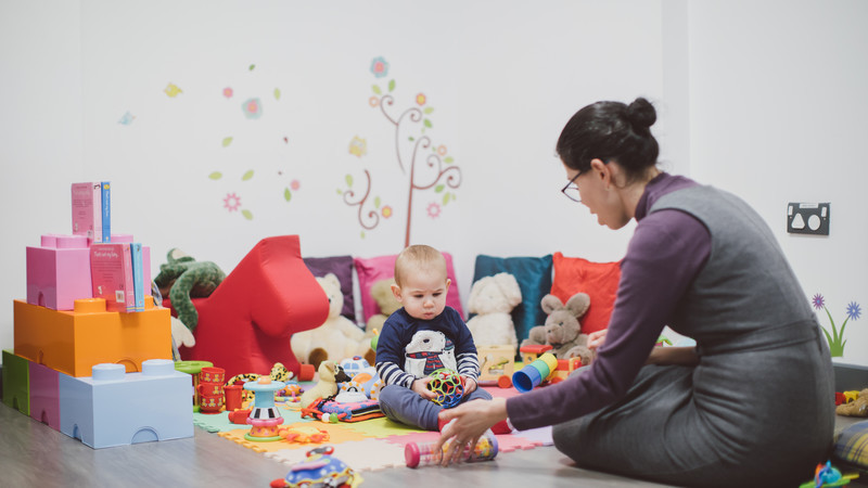 A Psychology Researcher observing a baby playing