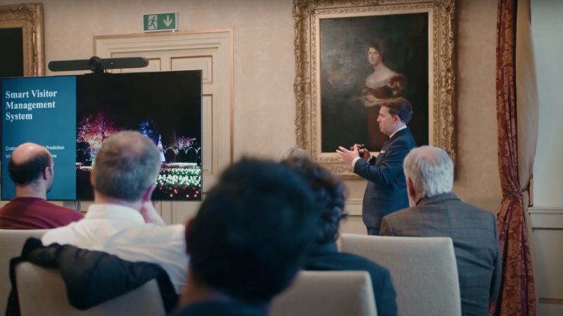 people in a room looking at a presenter