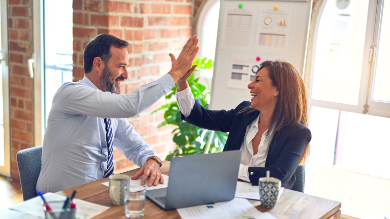 Two professionals high five eachother