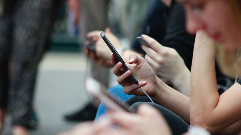 a group of people looking at their phones