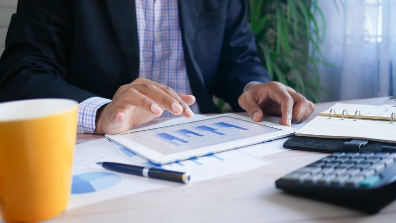 person sitting at a desk whilst working on a budget