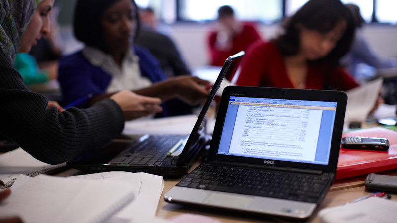 Students using a laptop[