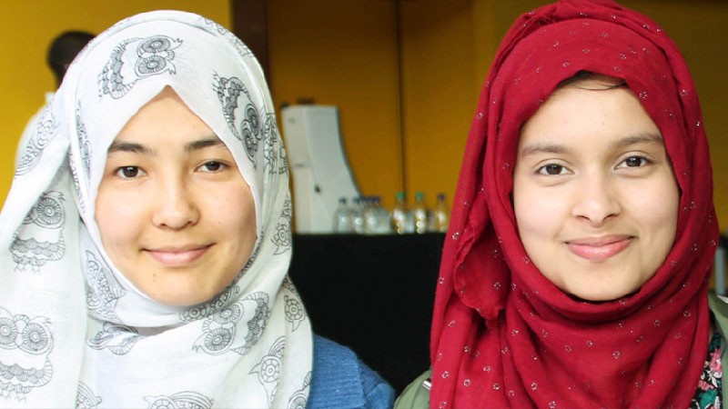 Two students looking at the camera