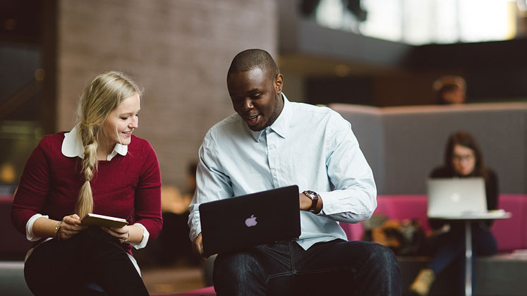 A member of staff helping a student