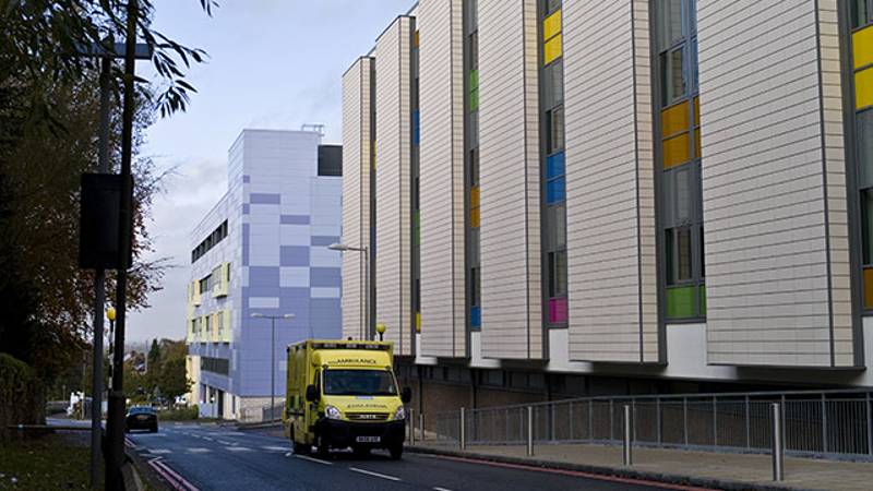 an ambulance driving past a building